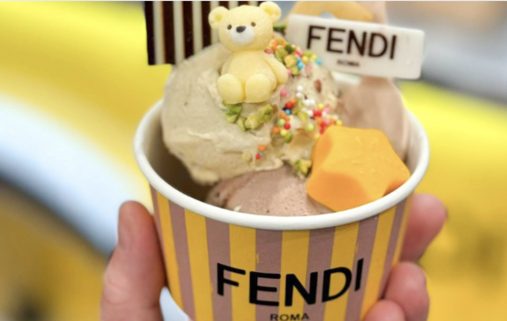 Stylish influencer holding a FENDI gelato cone in front of a pastel-colored branded cart in Seoul Stylish influencer holding a FENDI gelato cone in front of a pastel-colored branded cart in Seoul
