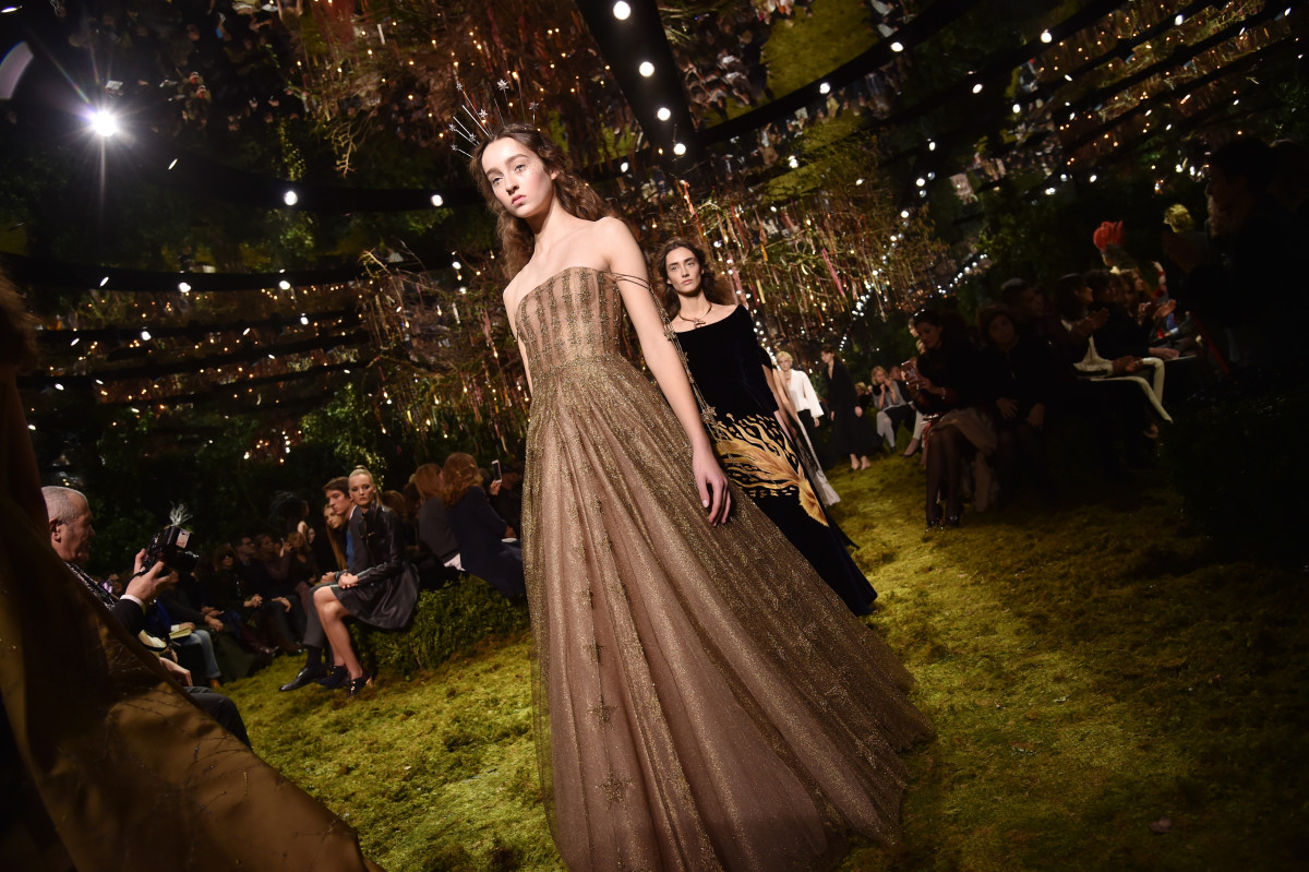 Models walking the runway in stunning gowns, with an ethereal atmosphere, embodying the empowerment of Dior's feminist philosophy. Models walking the runway in stunning gowns, with an ethereal atmosphere, embodying the empowerment of Dior's feminist philosophy.