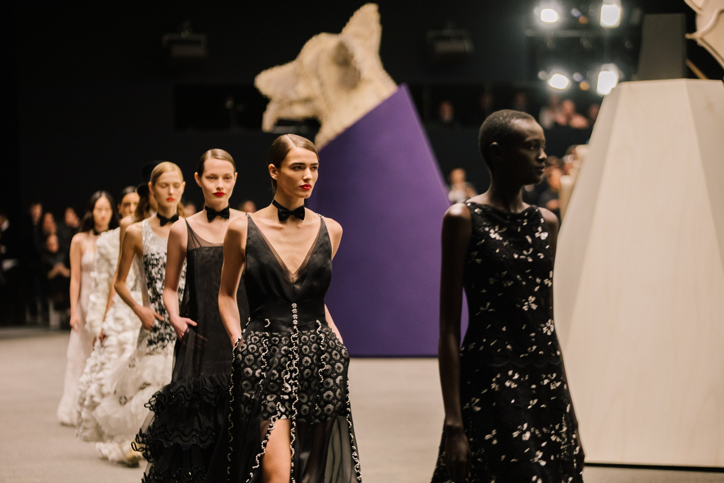 A noir-tinted tribute to elegance: eveningwear infused with texture, movement, and couture precision—where every step tells a story in black and white. A noir-tinted tribute to elegance: eveningwear infused with texture, movement, and couture precision—where every step tells a story in black and white.